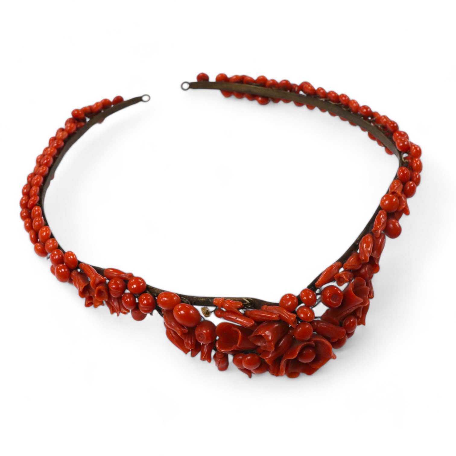 A 19th century base metal and coral bead floral designed tiara, approximately 40cm. Condition - poor to fair (some coral detached pieces in a small bag)